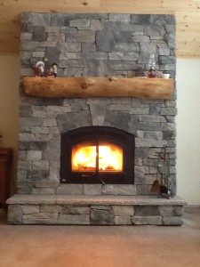 Granite stone veneer on wood burning fireplace