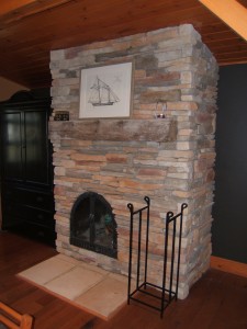 A refaced brick fireplaces with stone veneer