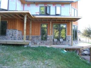 Natural field stone on far left matched to cultured stone wainscoting centre right