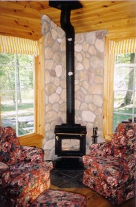 Cultured Stone river rock accenting wall behind wood burning fireplace