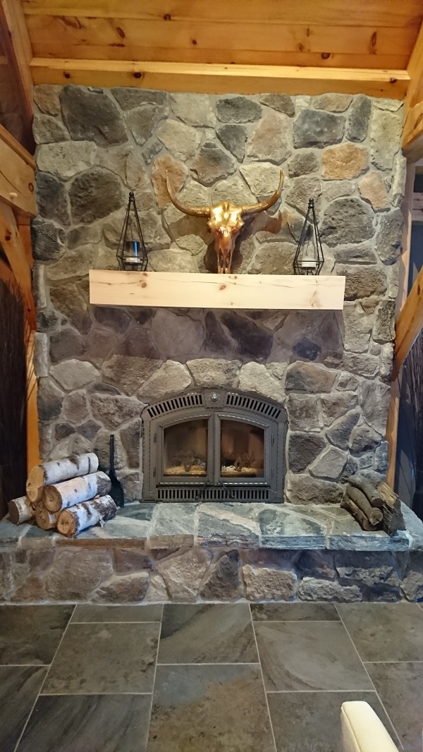 Stone veneer fireplace in Horseshoe Valley home