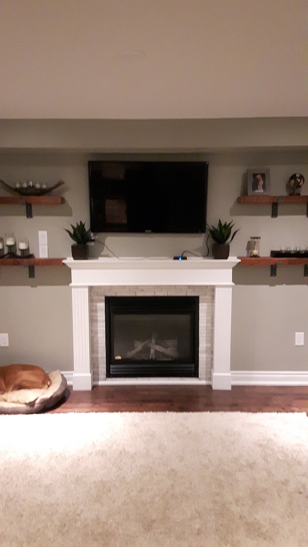 Living room wall with fireplace before addition of stone veneer.