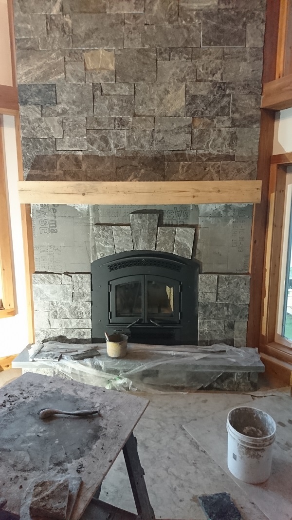 Granite veneer being applied to cement board.