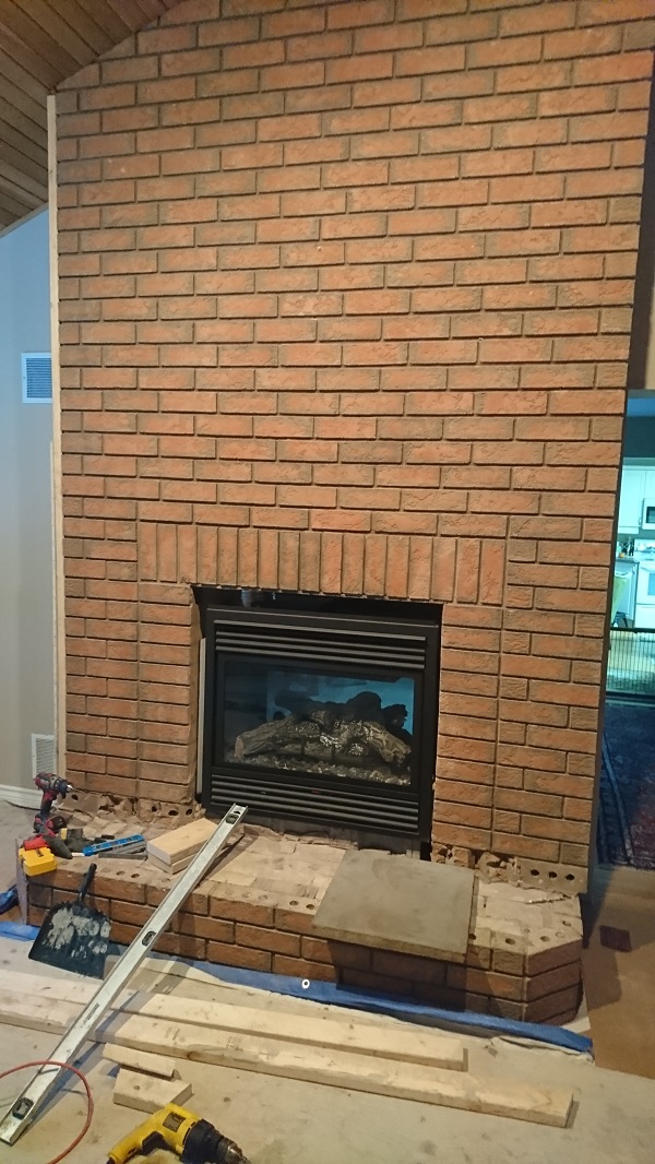 Brick fireplace before application of stone veneer over brick fireplace Brick fireplace before application of stone veneer over brick fireplace