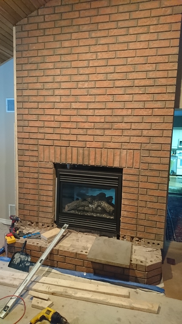 Brick fireplace before application of stone veneer over brick fireplace