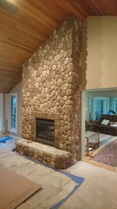 Dutch Quality stone veneer over brick fireplace.