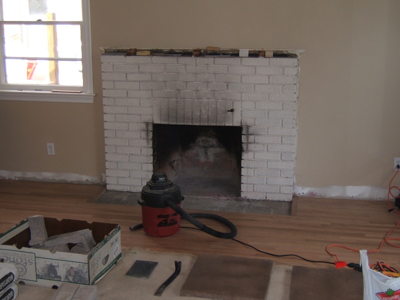 Painted brick fireplace before the addition of stone veneer. Painted brick fireplace before the addition of stone veneer.
