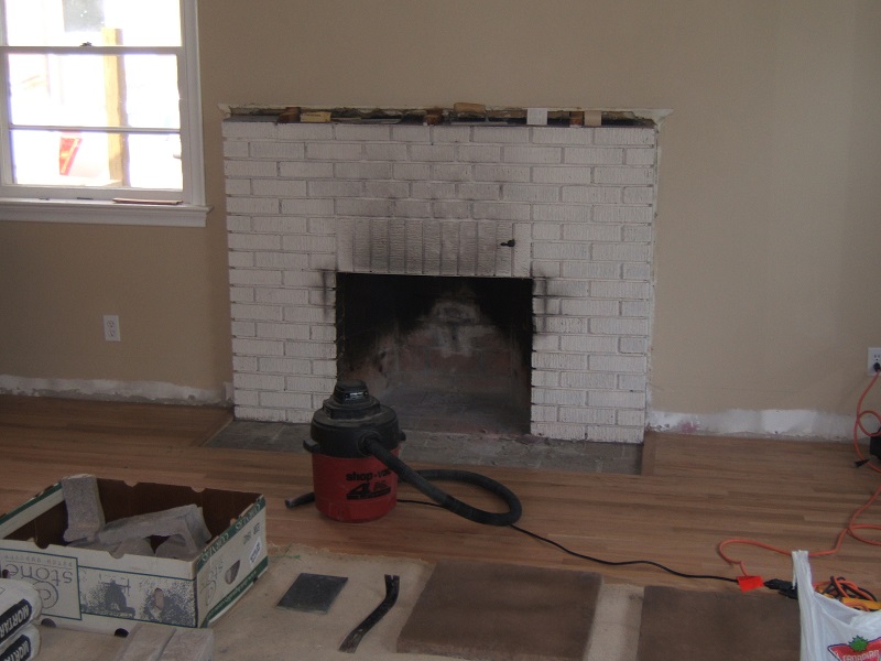 Painted brick fireplace before the addition of stone veneer.