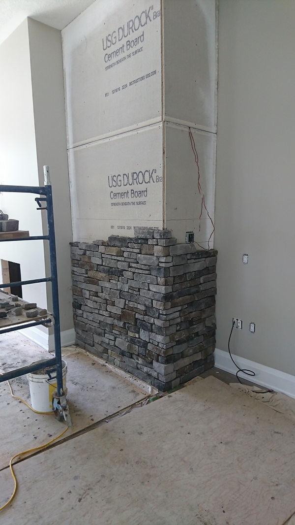 Stone veneer accent walls in process of stone being applied.