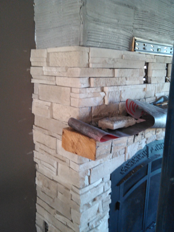 Close up of Dry Stack Stone with rustic beam on fireplace. Close up of Dry Stack Stone with rustic beam on fireplace.