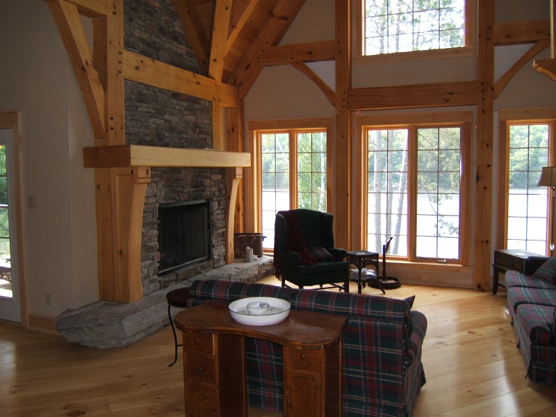 Post and beam mantle on stone fireplace