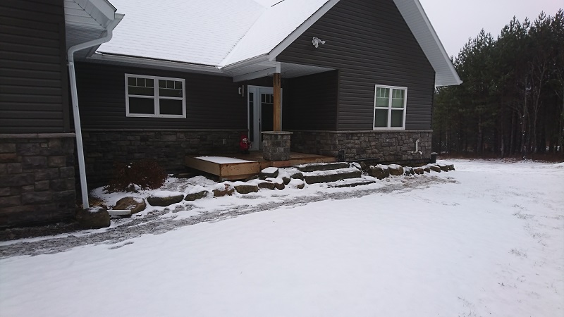 Stone veneer wainscot added to a cottage